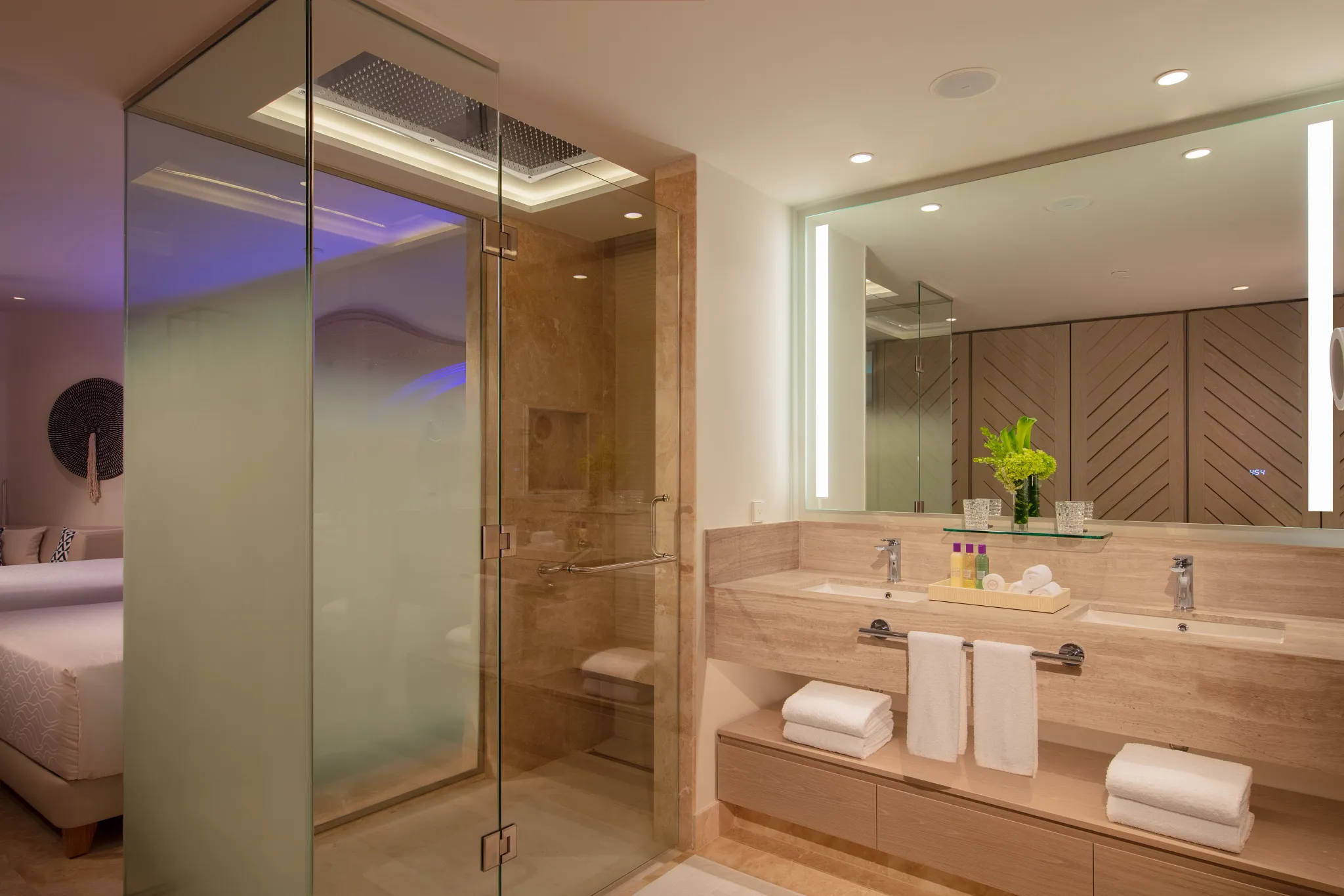 Modern bathroom in the Allure Junior Suite Live Big Lagoon View at Breathless Cancun Soul Resort with double vanity and glass shower.