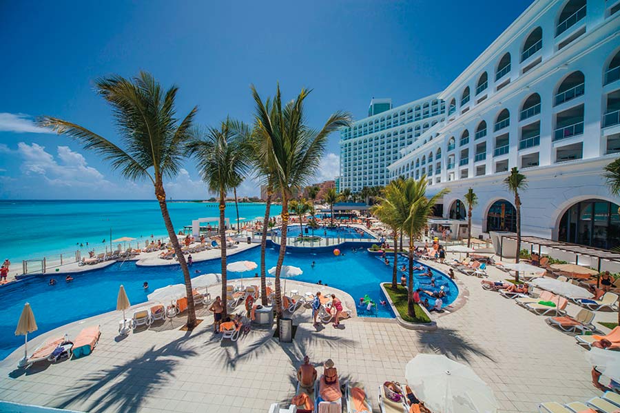 Hotel Riu Cancun all-inclusive beachfront resort with large pool complex in the Cancun Hotel Zone, Mexico.
