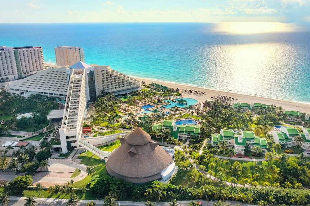 Iberostar Selection Cancun all-inclusive beachfront resort in Cancun’s Hotel Zone with large pool areas, palm-lined grounds, and Caribbean Sea views.