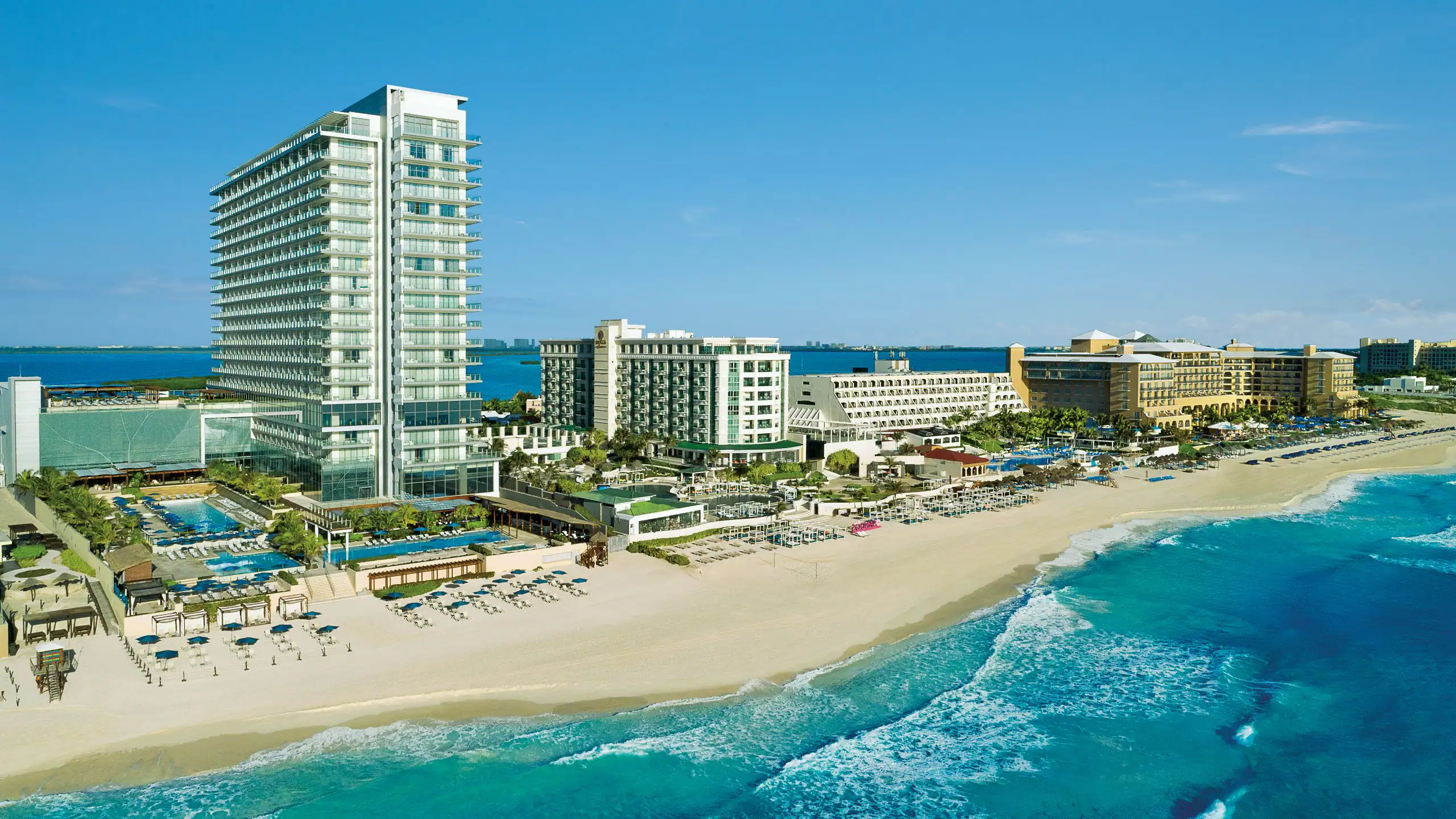 Secrets The Vine Cancun adults-only all-inclusive resort in Cancun’s Hotel Zone with tall beachfront towers, pools, and Caribbean Sea views.