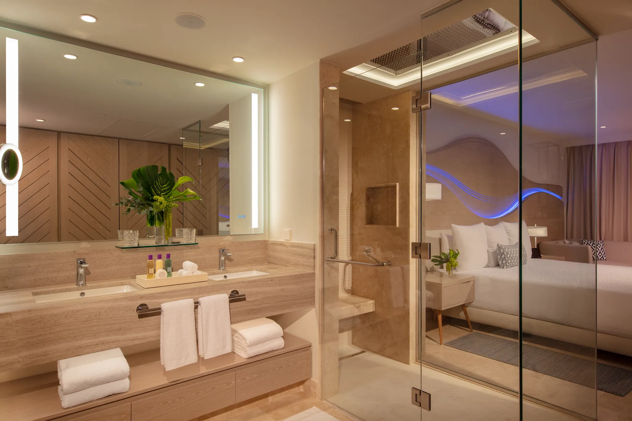 Modern bathroom in the Xcelerate Junior Suite Live Big Ocean Front at Breathless Cancun Soul Resort with double vanity and glass shower.