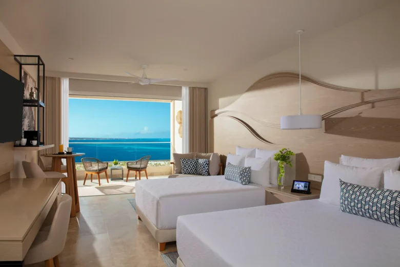 Xcelerate Junior Suite Live Big Ocean Front with double beds at Breathless Cancun Soul Resort overlooking the Caribbean Sea.