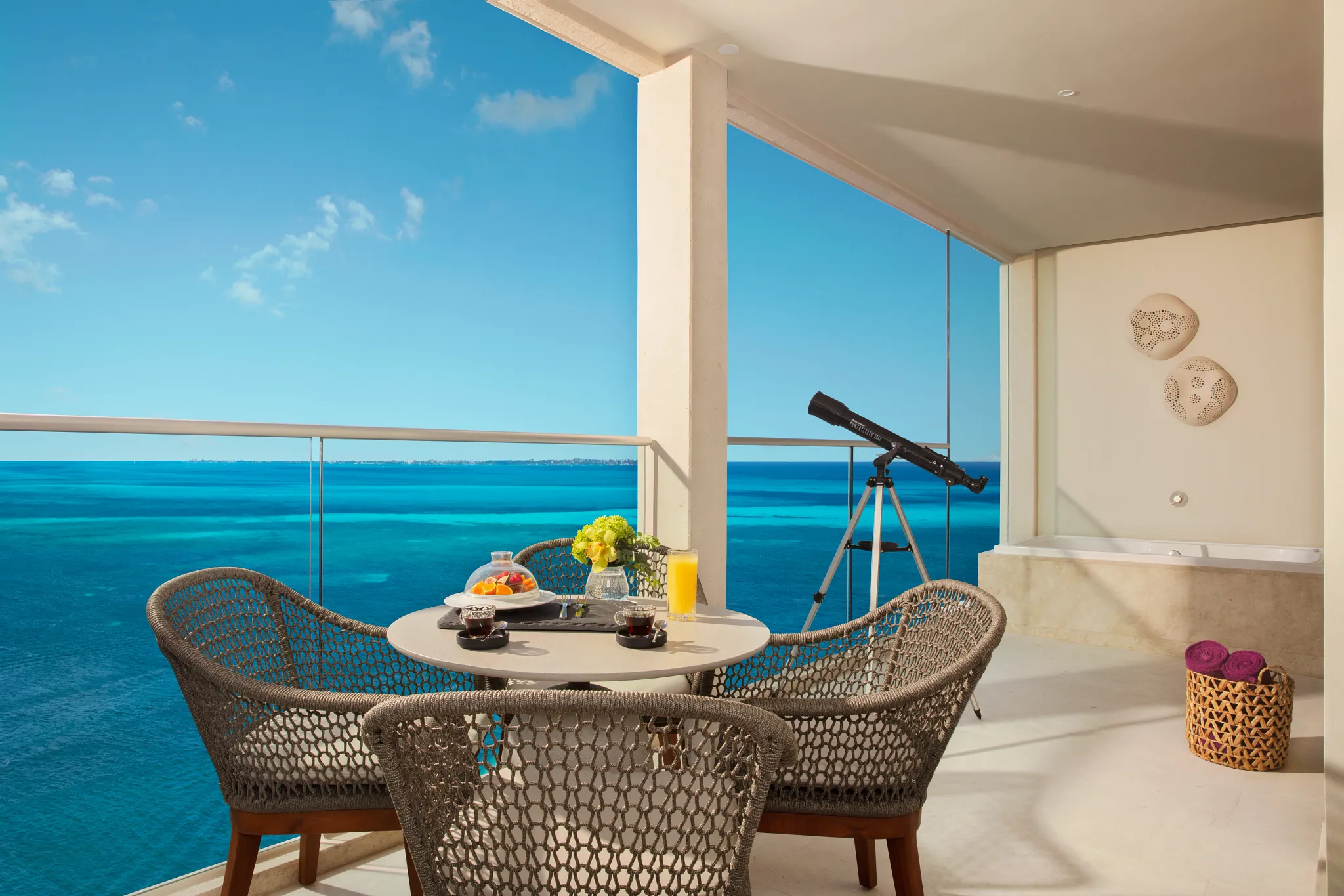 Private ocean-front terrace in the Xhale Club Master Suite at Breathless Cancun Soul Resort with seating and panoramic sea views.