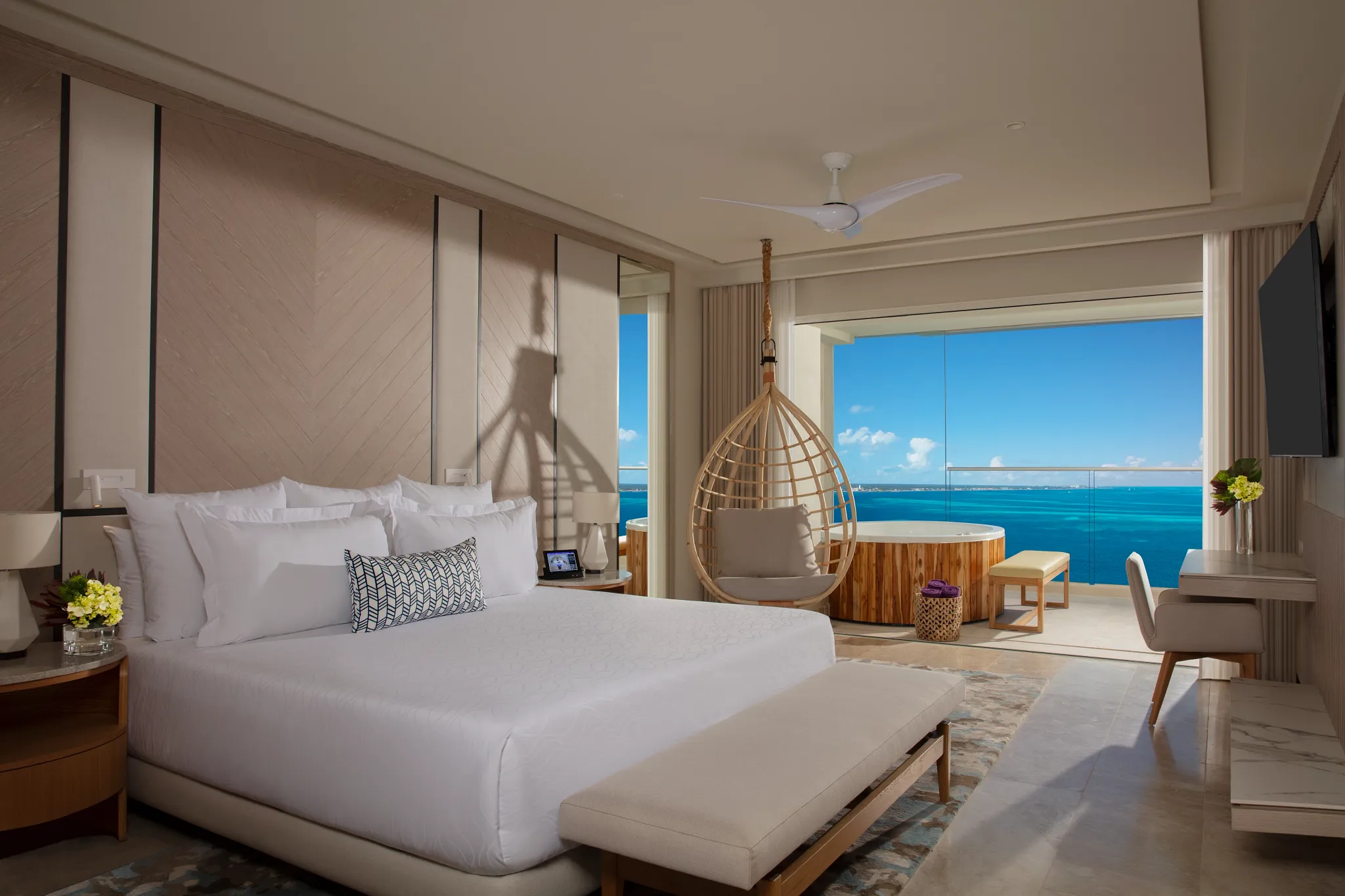 Ocean-front bedroom in the Xhale Club Presidential Suite at Breathless Cancun Soul Resort with king bed and panoramic Caribbean Sea views.